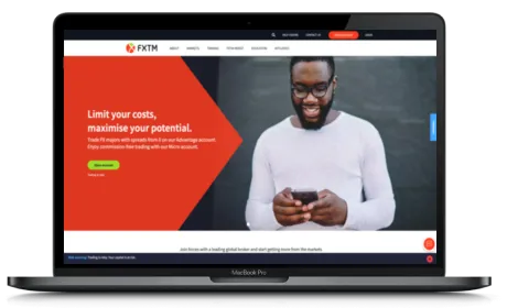 FXTM website displayed on a Macbook